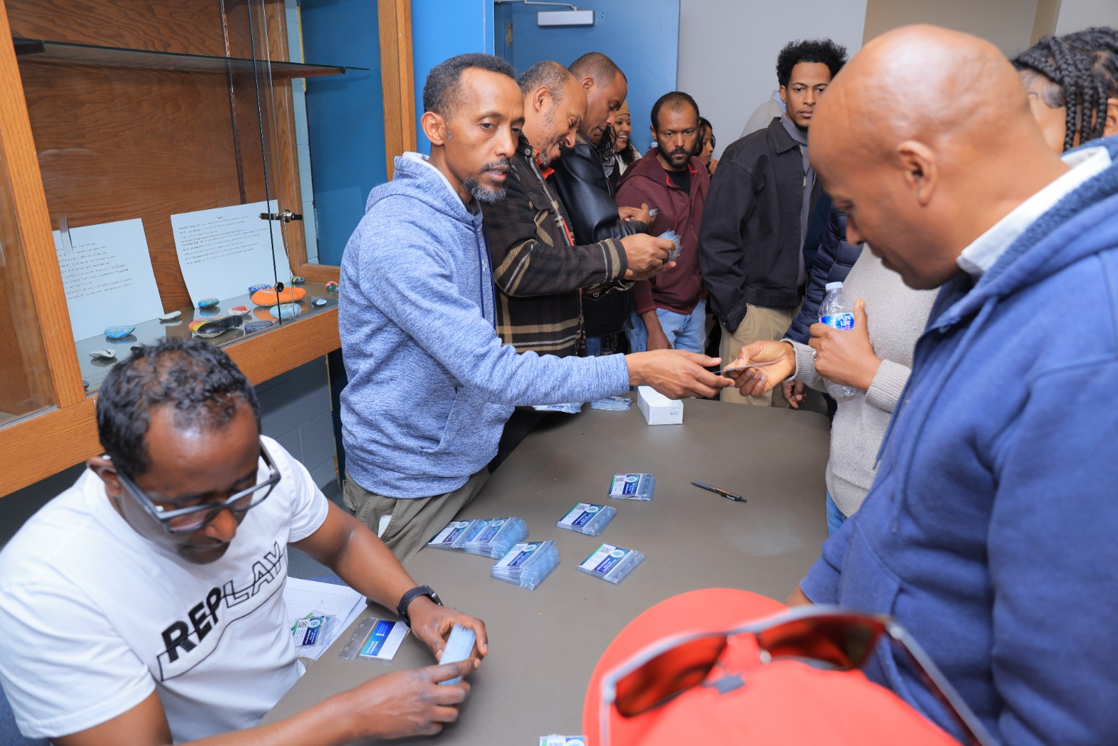 Members gather to receive their cards