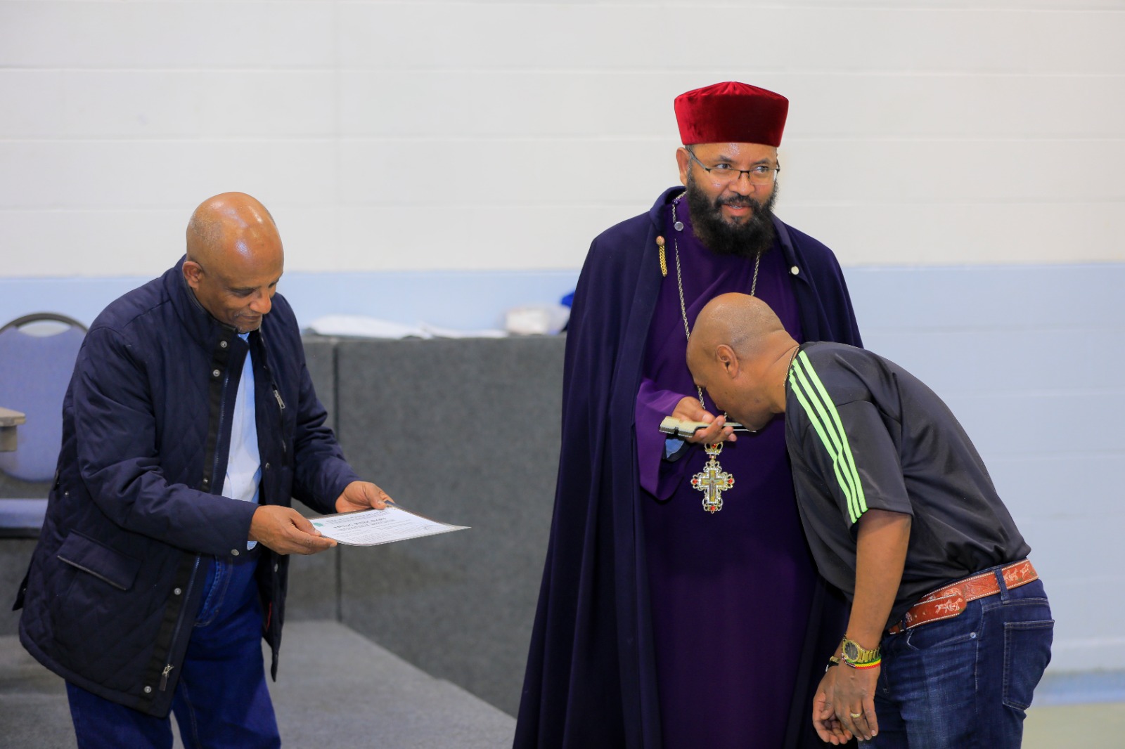 A member receives recognition and the priest's blessing