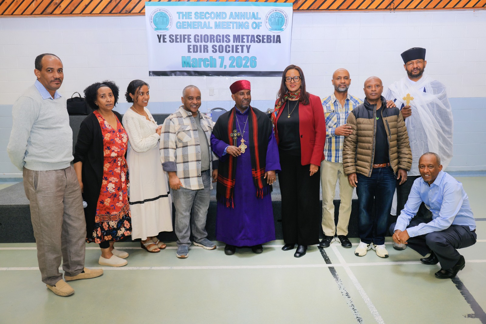 Committee and clergy gather beneath the event banner