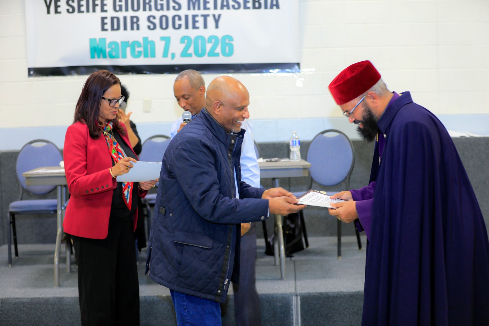 A member receives recognition from our clergy