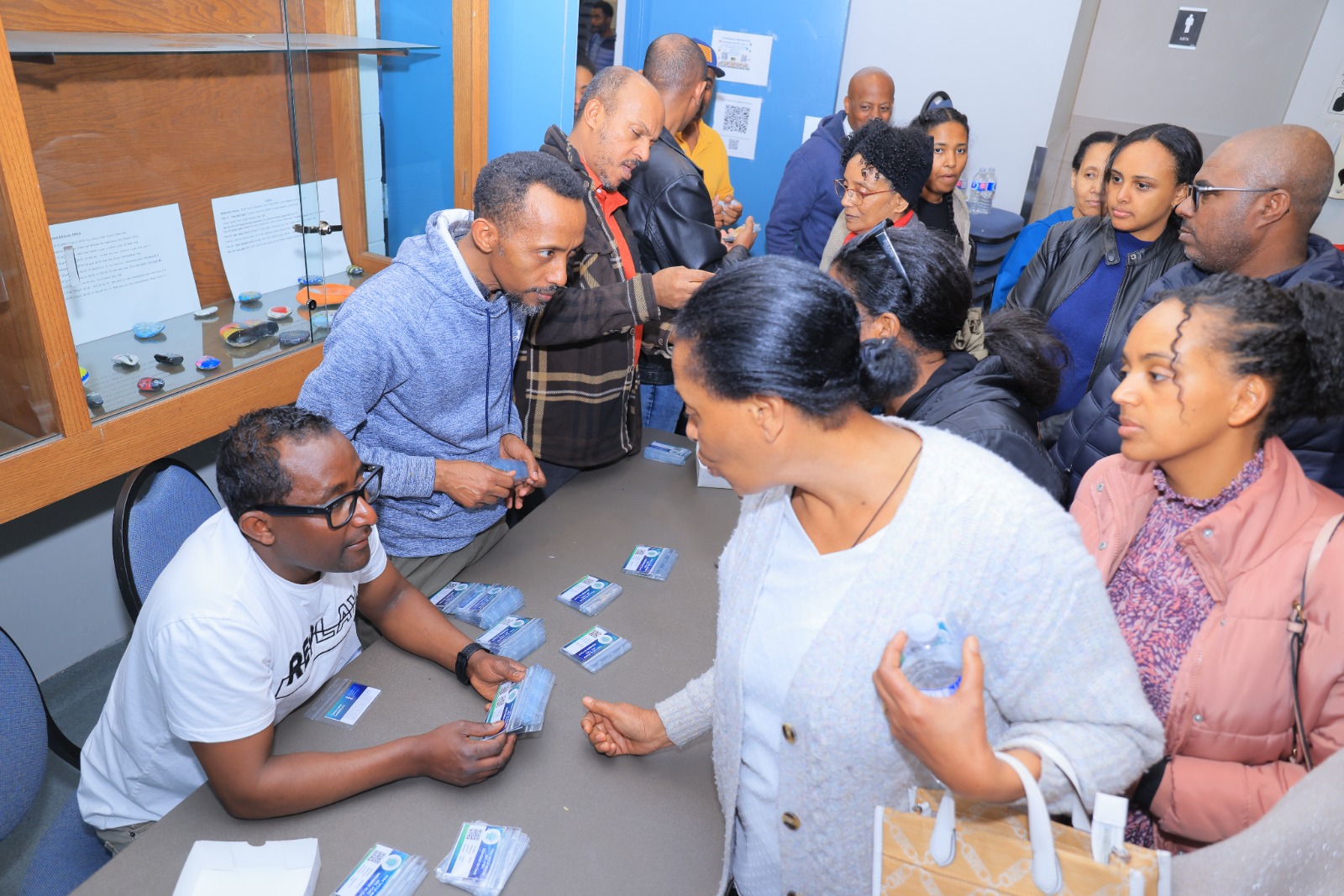 Members collect their membership cards at registration